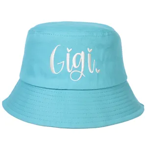 Close-up of a sky blue cotton bucket hat featuring white Gigi letter embroidery detail
