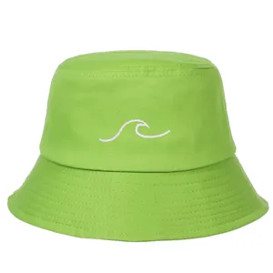 Detailed view of white wave embroidery on a lime green cotton bucket hat for summer