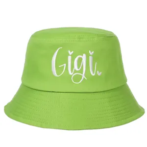 Detailed view of white Gigi cursive embroidery on vibrant lime green cotton bucket hat