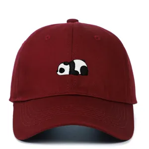 Detail showing a cute panda embroidery on a burgundy soft-top baseball cap.