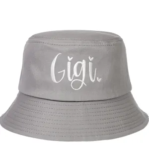 Close-up of white Gigi embroidered lettering on a premium grey cotton sun bucket hat