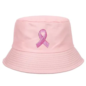 Detail view of pink bucket hat with embroidered breast cancer awareness ribbon logo