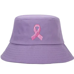 Detailed view of a purple bucket hat featuring a pink breast cancer ribbon embroidery