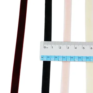 Close-up detail shot of 1cm colored velvet ribbons with a measuring ruler for sizing check.