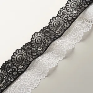Close-up detail of 9cm stretch lace trim in black and white, ideal for sewing and DIY crafts.