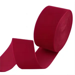 Detailed closeup view of 4cm red velvet ribbon roll, perfect for crafts, gift wrapping & DIY bows.
