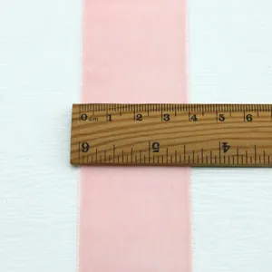 Pink velvet ribbon detail, 4cm width measured with ruler, ideal for crafts and gift wrap.