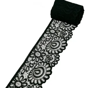 Close-up of 9cm black stretch lace trim, intricate floral and paisley pattern for sewing DIY.