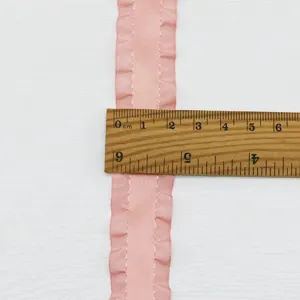 Detailed view of 2.2cm pink pleated satin ribbon with ruler measuring width for gift wrapping.