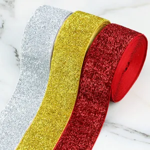 Detailed view of 4cm glitter elastic velvet ribbon rolls in silver, gold, and red colors.