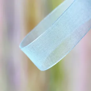 Close-up detail of light blue sheer organza ribbon showcasing delicate translucent texture.