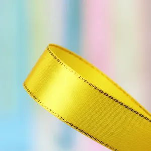 Yellow silver-edged satin ribbon 2.5cm wide for gift wrapping and cake box decoration.