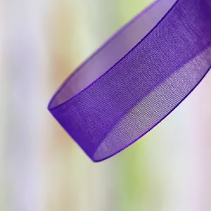 Purple organza ribbon detail close-up, showing sheer texture and delicate fabric weave.