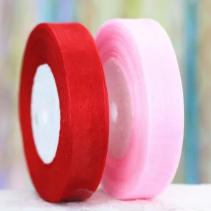 Organza ribbon rolls detail close-up view red pink gift wrapping fabric spool showcase