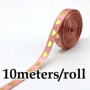 Nastro rosa con stampa di cuori d'oro, vista dettagliata ravvicinata per confezione regalo.