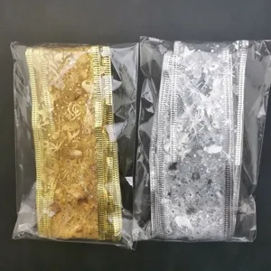 Close-up detail of sheer organza wired ribbons in gold and silver, perfect for gift wrap.