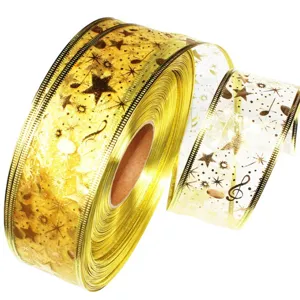 Detail view of 5cm transparent organza metallic wired ribbon with star and music note prints.