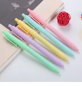 Macro view of five macaron colored retractable gel pens in pink, blue, yellow, and green.