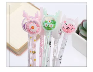 Close-up detail of cute cartoon animal sequin gel pens with flower shaker tops