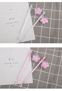 Detailed view of cherry blossom pendant gel pens with glittering pink sequins and sand
