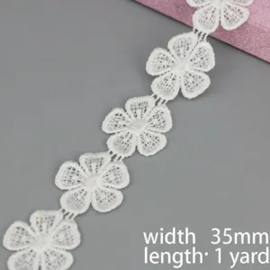 Close up of white water soluble lace trim, floral embroidered ribbon, 35mm width, 1 yard.