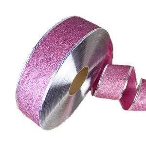 Pink glitter ribbon detail, 5cm width, shimmering surface with silver edge for gift wrapping.