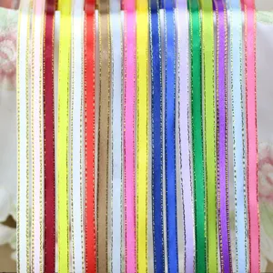 Close-up detail of colorful satin ribbons with metallic gold edges, ideal for gift wrapping.