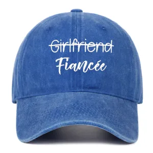 Front detail view of blue washed vintage baseball cap with white Fiancee embroidery.