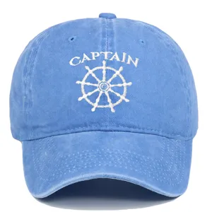 Vintage washed blue baseball cap featuring white Captain embroidery and a ship wheel.