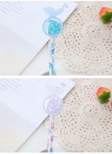 Close-up of butterfly-shaped pen top filled with sparkling blue and pink heart-shaped sequins
