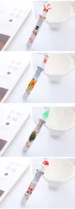 Detailed close-up of festive 10-color ballpoint pens with cute Christmas toppers