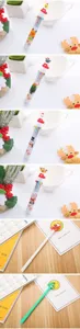 Detail view of festive Christmas multi-color ballpoint pens with cute silicone toppers.