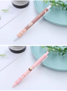 Close-up of cute cartoon bear retractable gel pens in pink and brown pastel colors