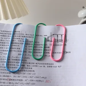 Detail shot of large colored plastic-coated metal paper clips, neatly clipped on paper.