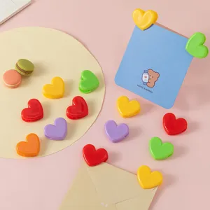 Colorful heart-shaped plastic clips for photo display, memo notes, and cute stationery setup.