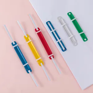 Colorful plastic and metal file fasteners set for office school paper organization and binding.