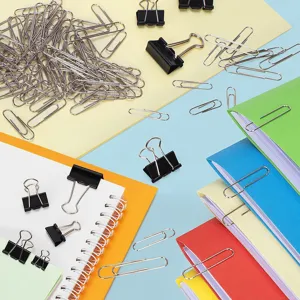 Detail view of colorful binder clips, paper clips, and folders for office and school organization.