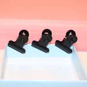 Black metal binder clips for office and school stationery organization and paper holding.
