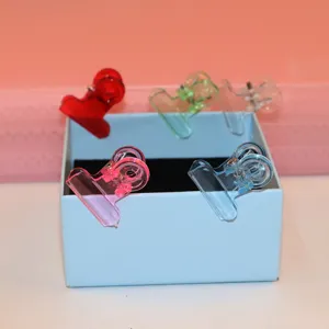 Transparent acrylic binder clips detail showing colorful translucent paper clamps for office use.