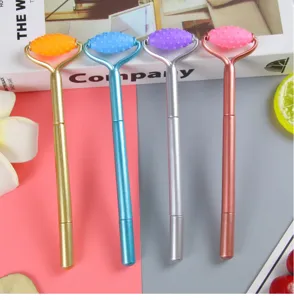 Four colorful electroplated massage roller pens in gold silver blue and rose gold colors