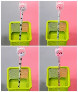 Detailed view of four cute cartoon cat gel pens with glitter sequins in a desk organizer