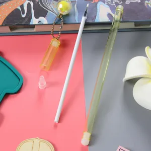 Detailed view showing the components of a creative gel pen including refill and pendant charm