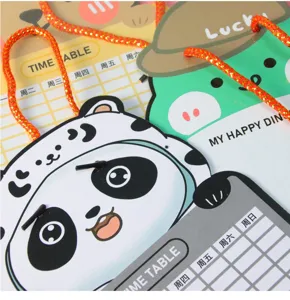 Close-up of cartoon panda and frog shaped erasable whiteboards for children's schedules.