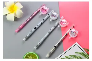 Macro view of cute cat-shaped gel pens with shimmering sequins and cartoon prints.