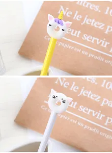 Close-up detail of cute unicorn and cat donut toppers on cartoon gel pens