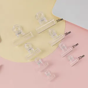 Transparent plastic binder clips multi-size set for office document organization and floral crafts.