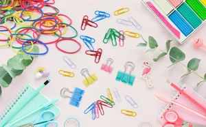 Colorful paper clips and binder clips set for office and school document organization.