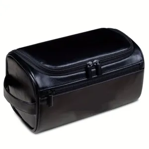 Detail showing the black PU leather texture and dual zipper of this men's wash bag