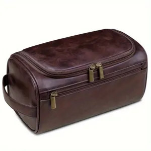 Side view showing the durable handle and multiple zipper compartments of the brown bag.