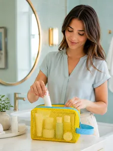 Yellow mesh cosmetic bag with blue zipper and handle, perfect for travel and daily makeup storage.